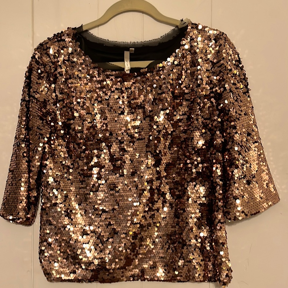 Beautiful copper color top would look great with black pants.